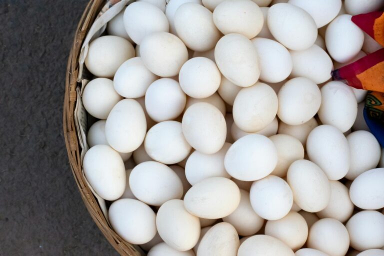 A basket full of eggs with colorful ribbons